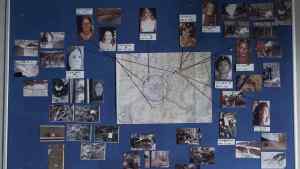 The murder map, with photos of a selection of Hansen’s victims with string pointing to where they were found, and crime scene photos