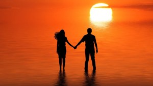 Couple on beach at sunset