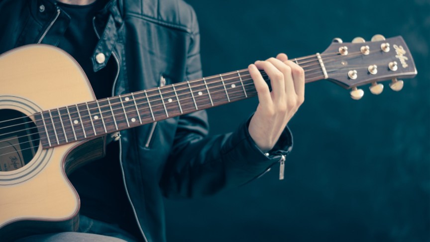 A man playing a guitar.