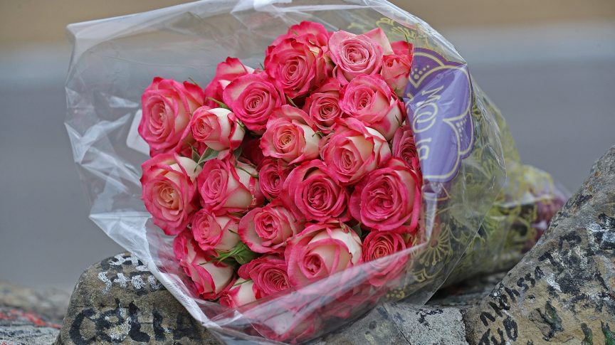 Flowers left by fans outside Graceland.
