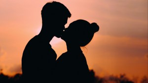 A couple kissing.