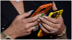 A social media influencer holds her phones.