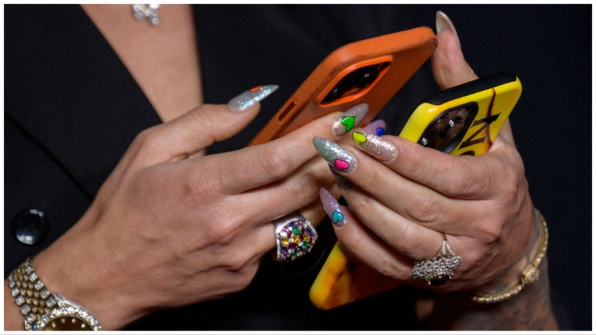 A social media influencer holds her phones.