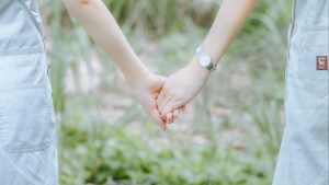 Women holding hands.
