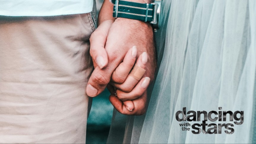 A couple holding hands.