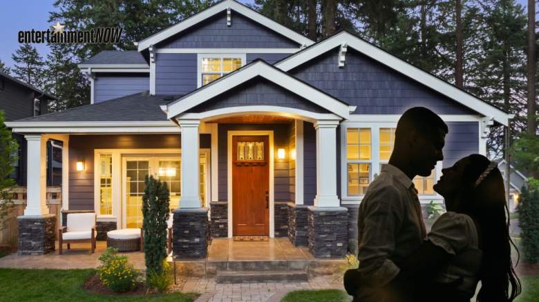 A couple in front of a house.