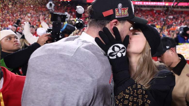 Travis Kelce and Taylor Swift kiss on the field while celebrating his AFC championship win