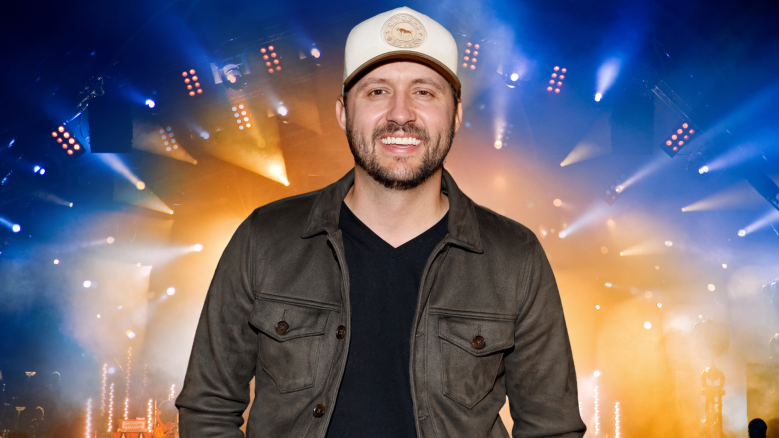 Drew Baldridge smiling in front of a colorful stage