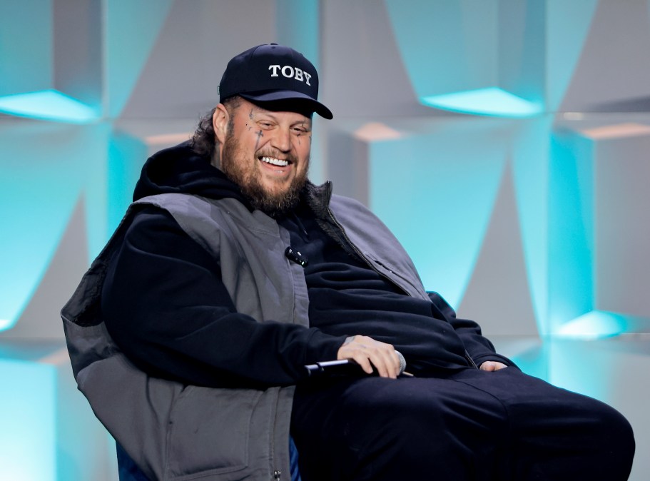 Jelly Roll smiling in a tracksuit