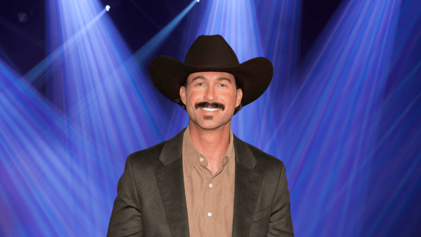 Riley Green wears a cowboy hat and smiles