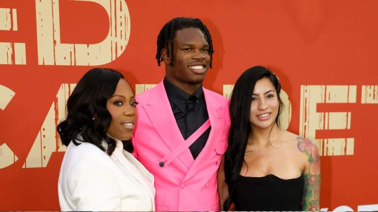 Travis Hunter poses at the NFL draft with his mother and Leanna Lenee.