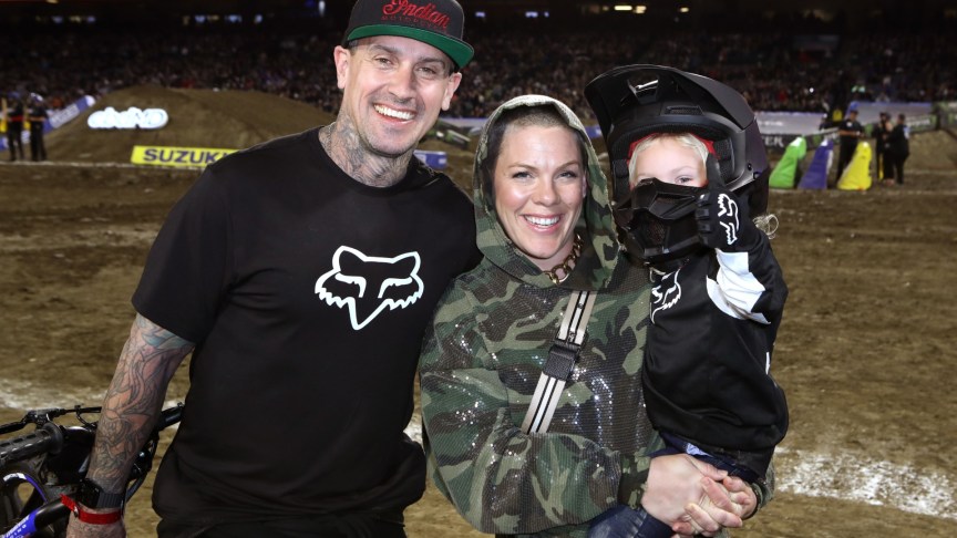 Carey Hart and Pink smiling with their child