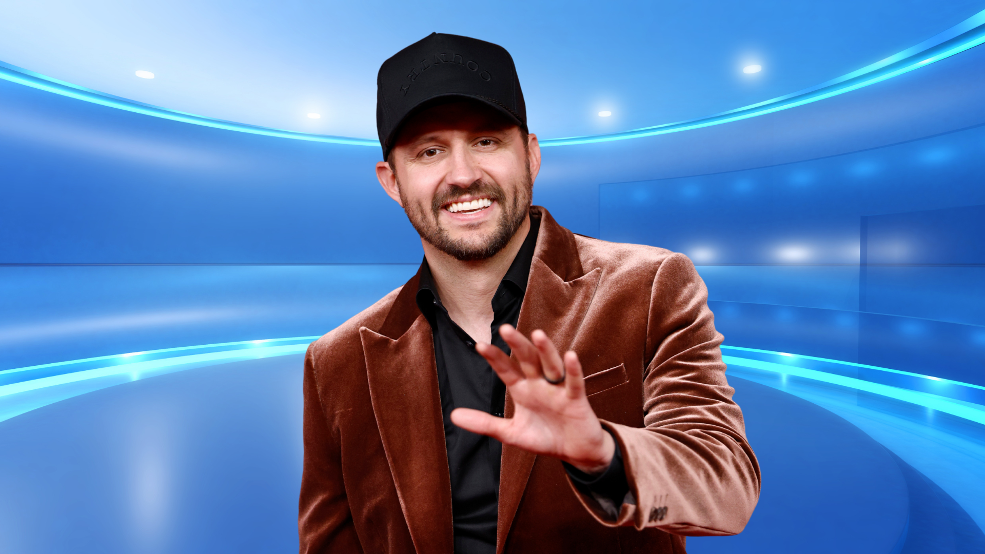 Drew Baldridge smiling in a velvet blazer