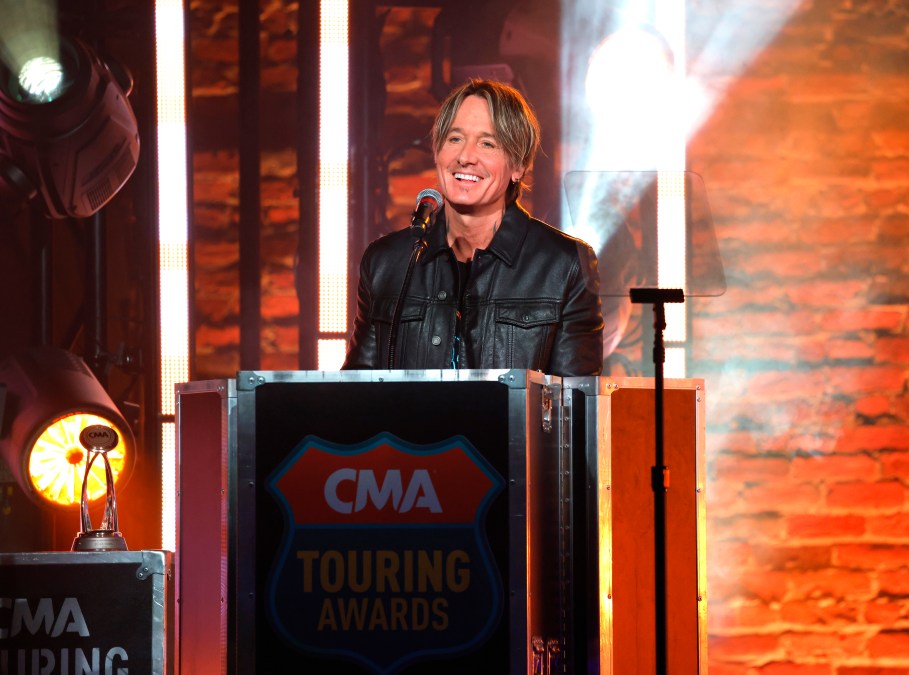 Keith Urban stands behind a podium