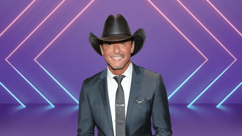 Tim McGraw smiling on a colorful stage