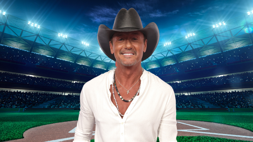 Tim McGraw smiling on a baseball field