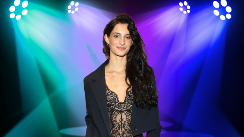 Audrey McGraw posing under colorful lights