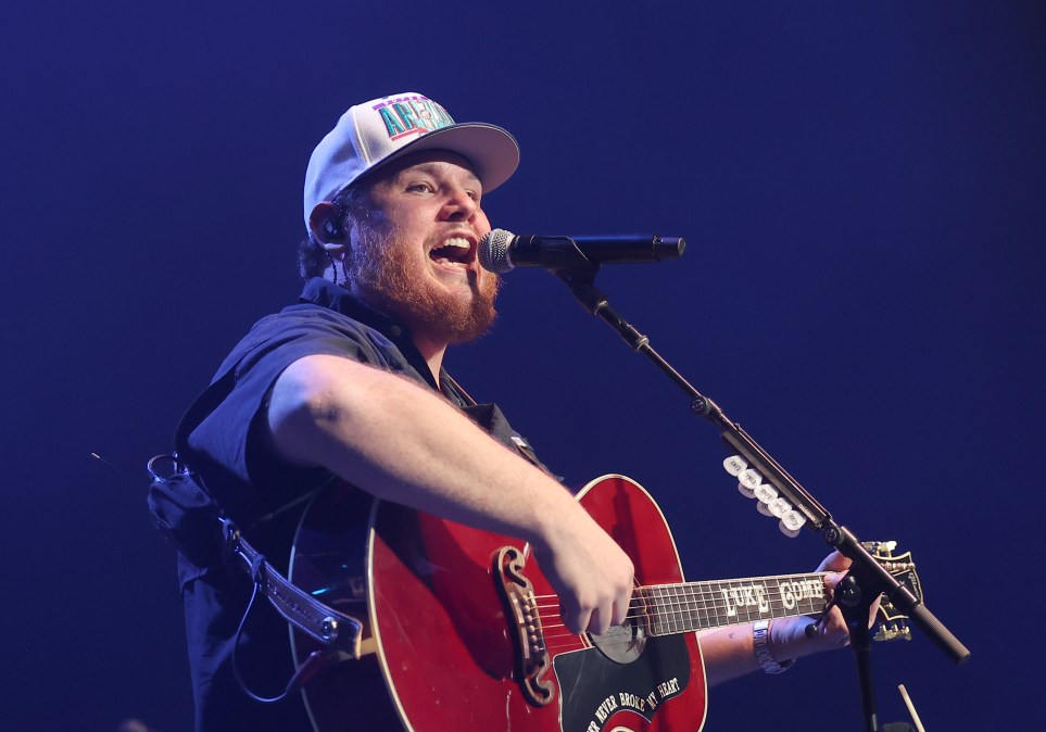 Luke Combs singing into a microphone