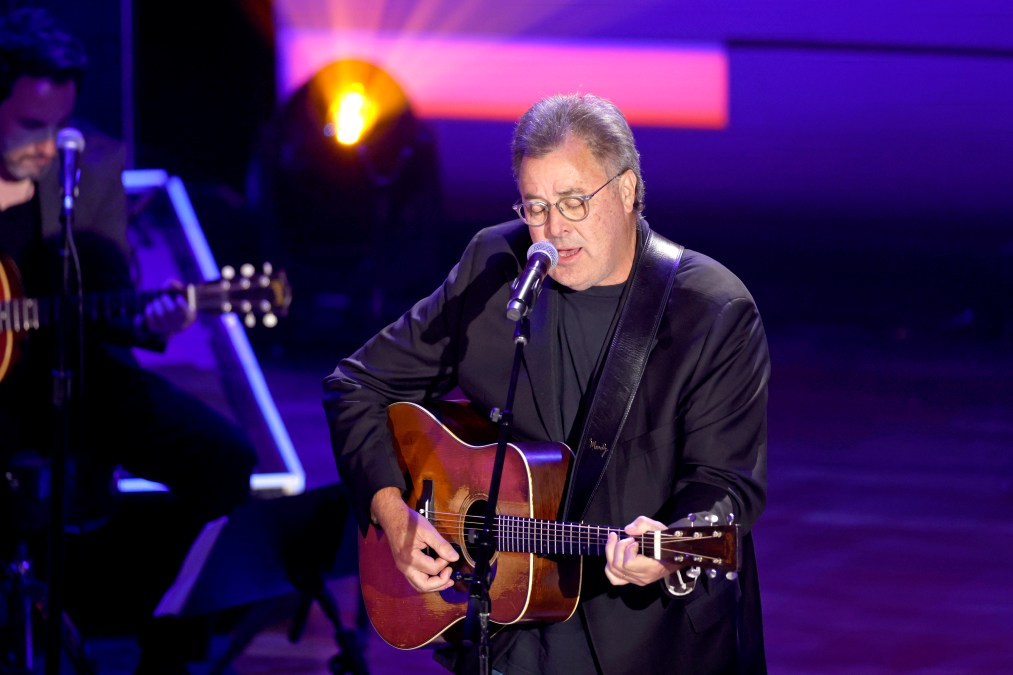 Vince Gill playing guitar and singing