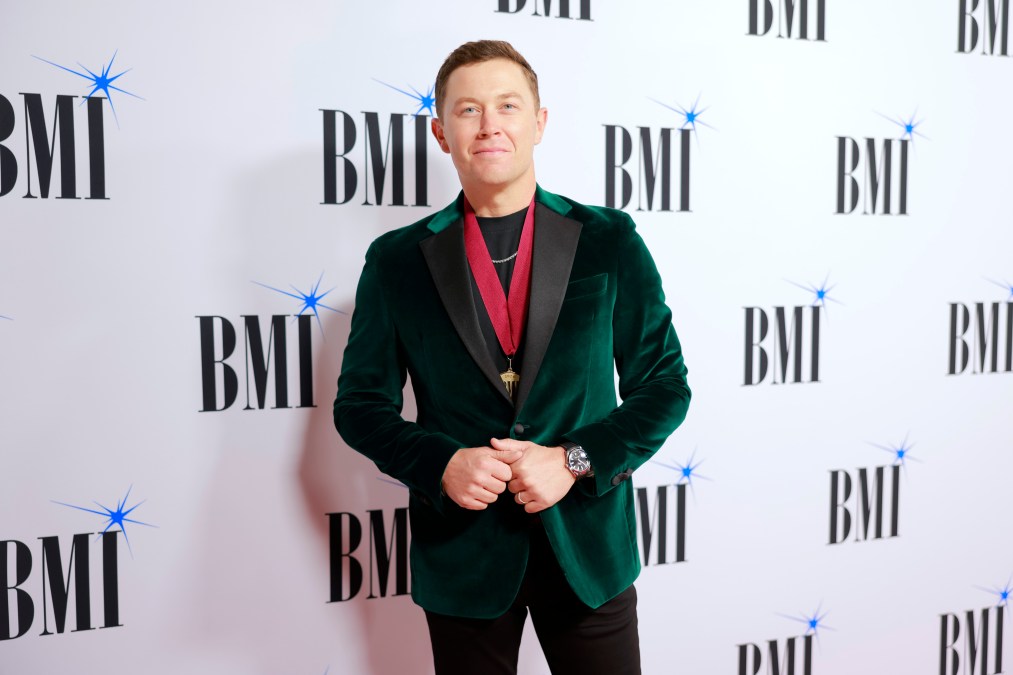 Scotty McCreery posing in a velvet jacket.