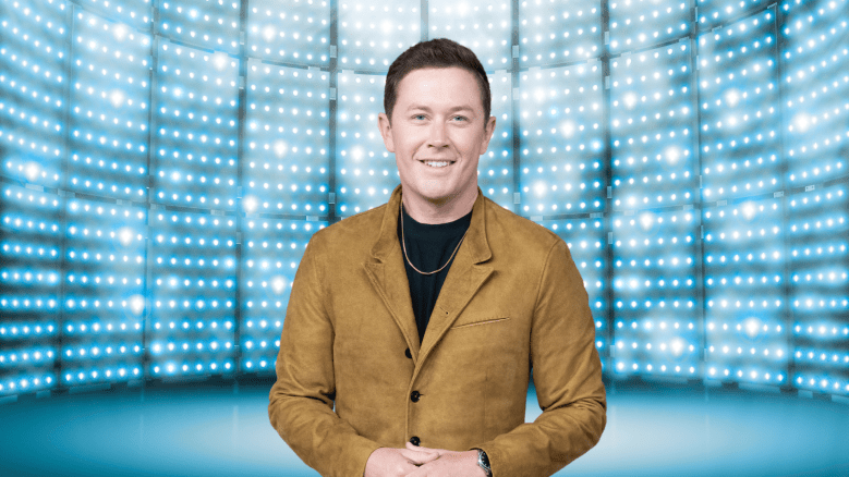 Scotty McCreery posing on a colorful stage