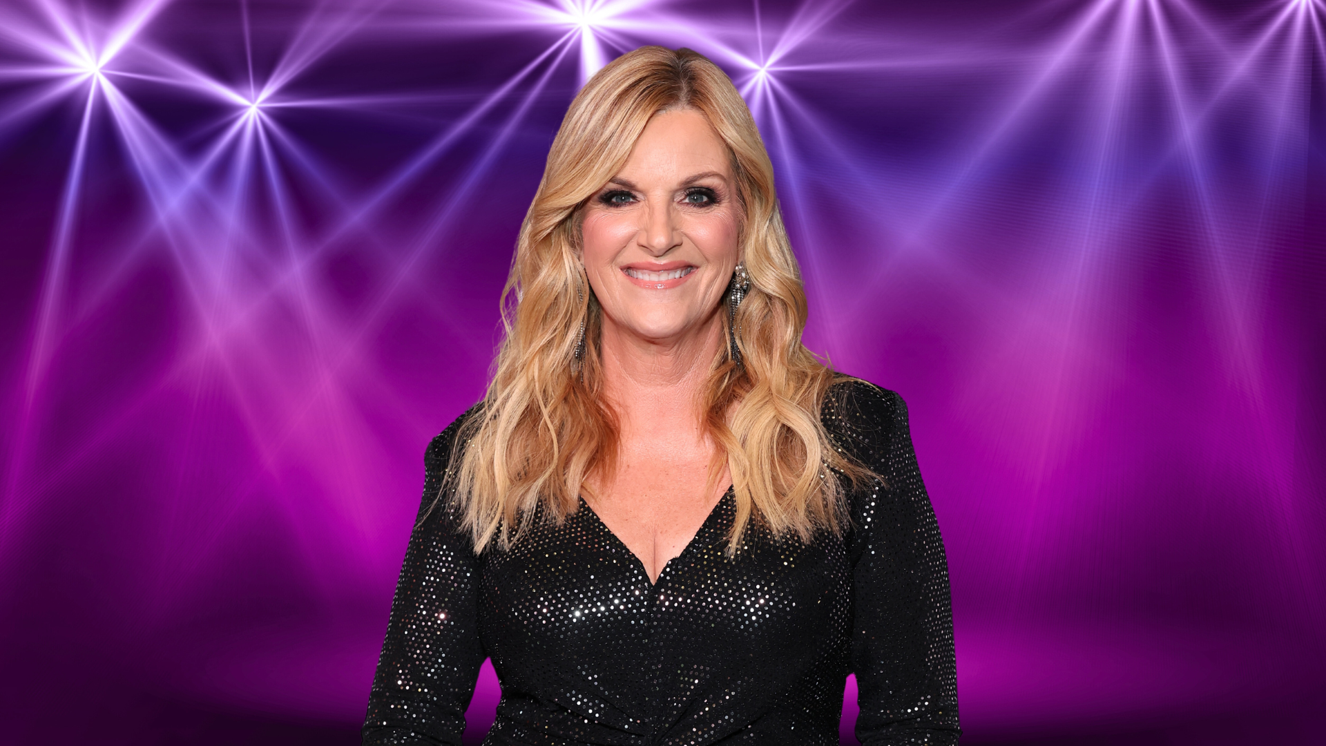 Trisha Yearwood smiling in front of colorful lights