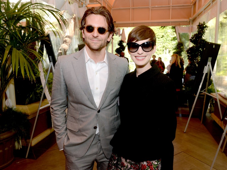 Actors Bradley Cooper (L) and Anne Hathaway