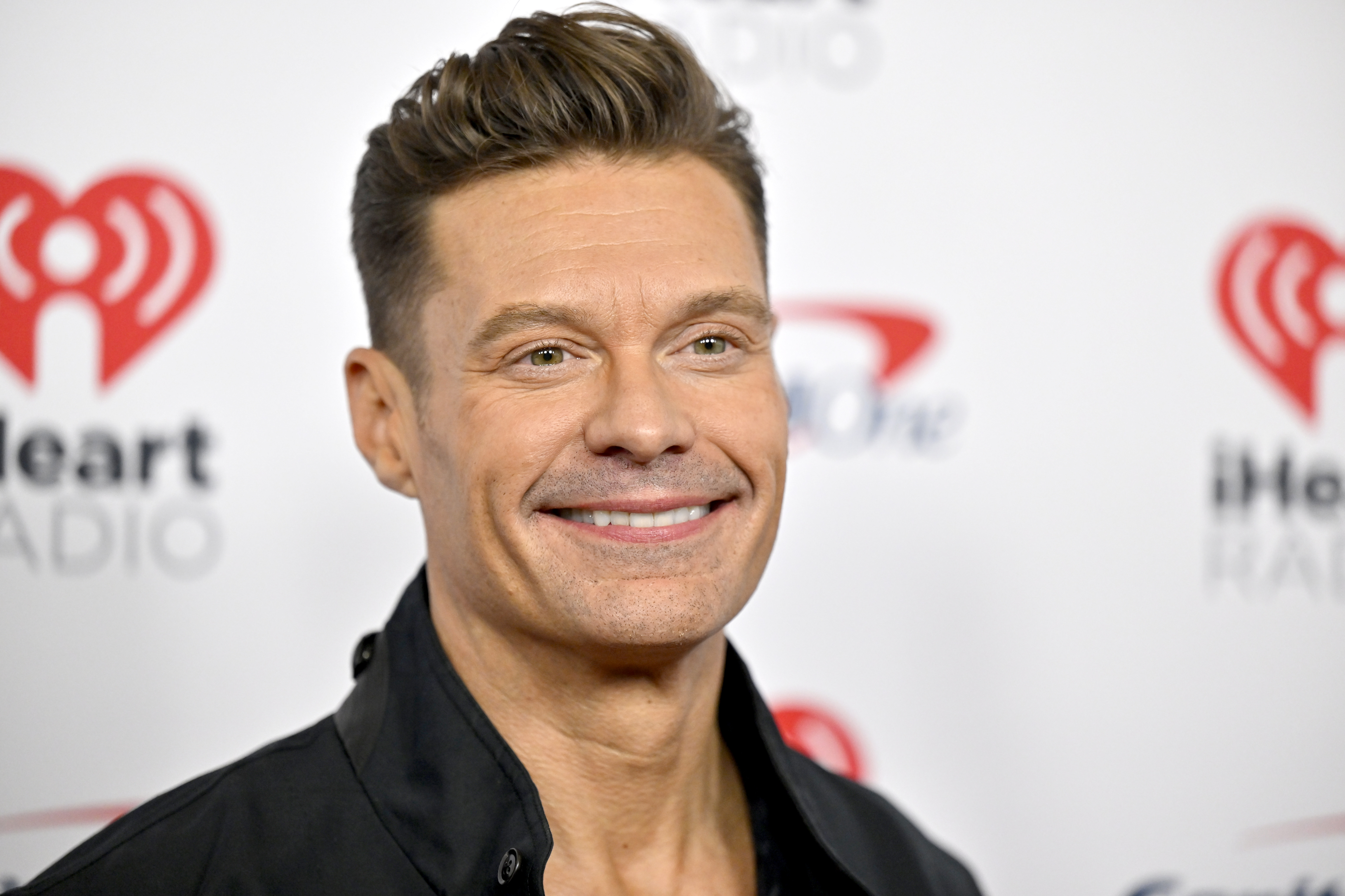 Ryan Seacrest posing for a photo