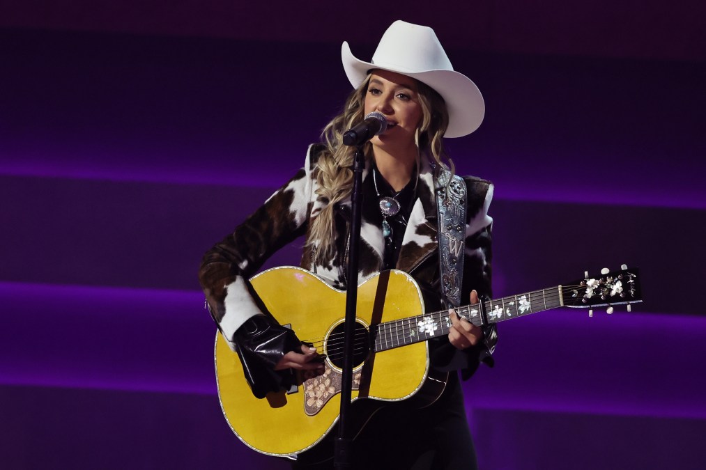 Lainey Wilson performing on stage.
