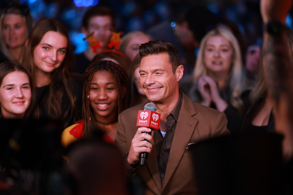 Ryan Seacrest smiling in a crowd