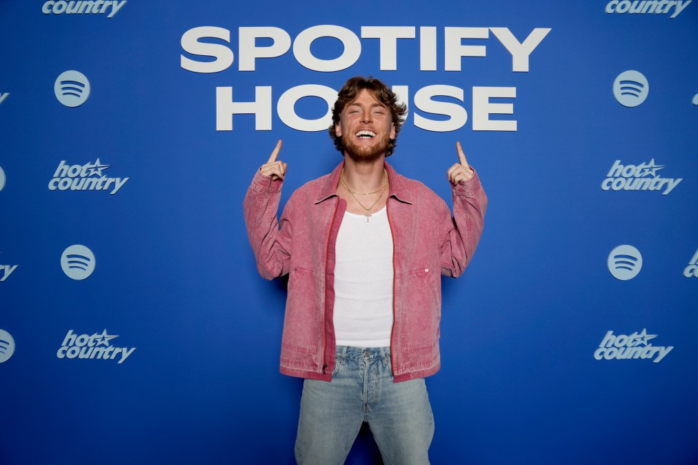 Bailey Zimmerman smiling in front of a Spotify House step and repeat.