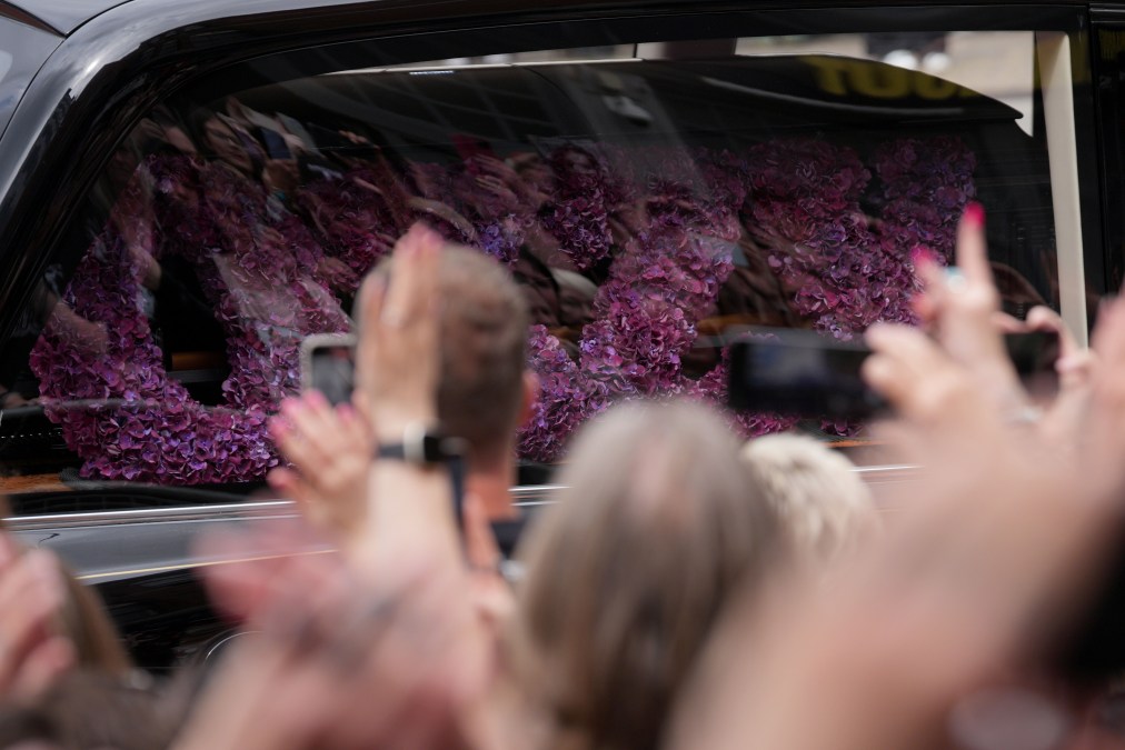 Flowers adorn the coffin as the funeral cortege for Ozzy Osbourne travels through his home city of Birmingham on July 30, 2025