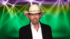 Toby Keith posing on a colorful stage.