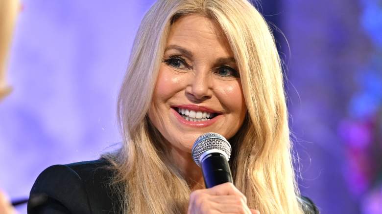 Christie Brinkley smiling and talking into microphone