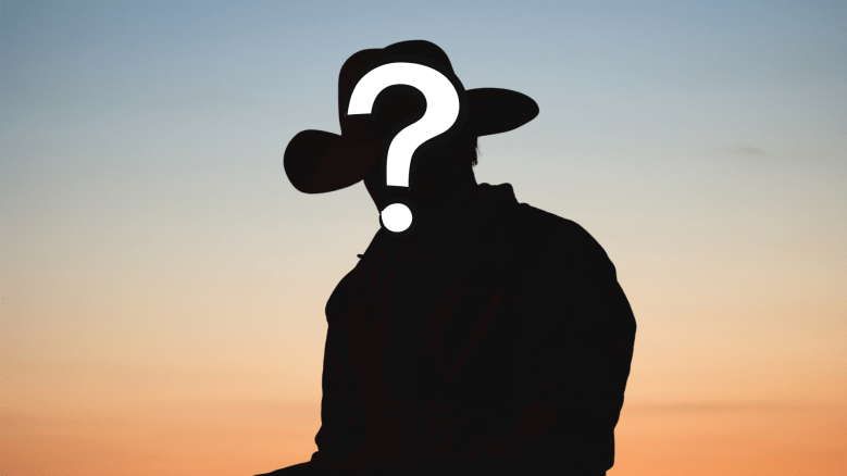 A silhouette of a cowboy against a sunset