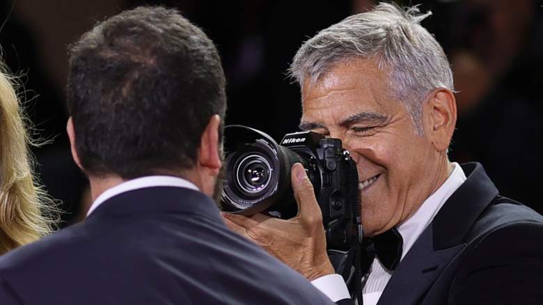 George Clooney photographing Adam Sandler at the Venice Film Festival