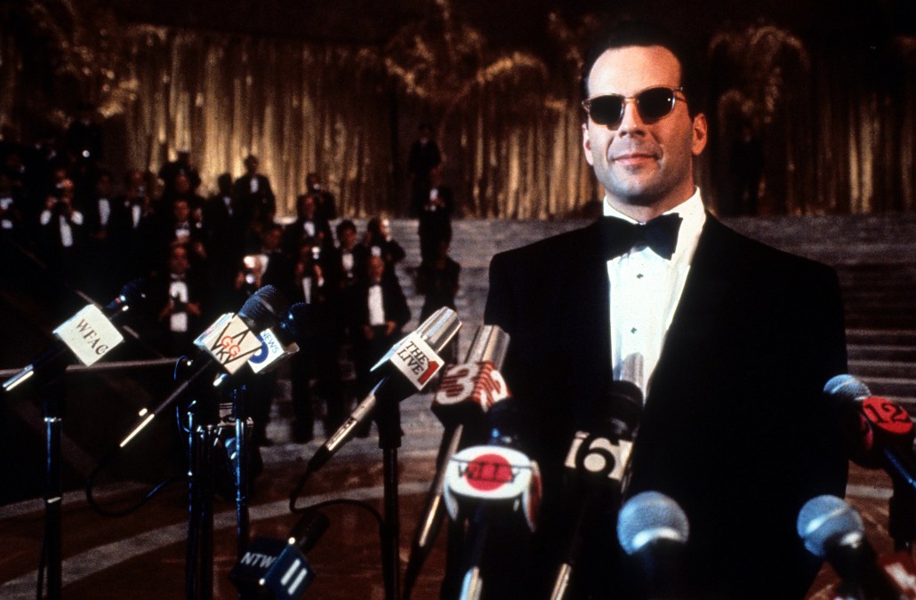 Bruce Willis at a press conference in a scene from the film 'The Bonfire of the Vanities', 1990.