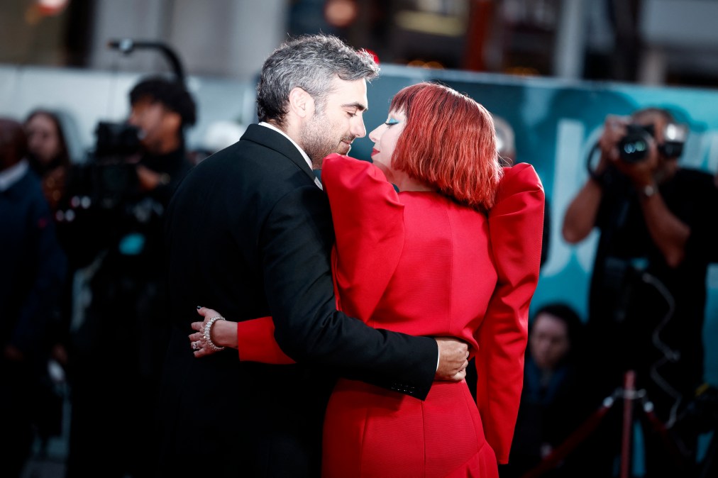 US singer-songwriter and actor Lady Gaga poses on the red carpet with Michael Polansky