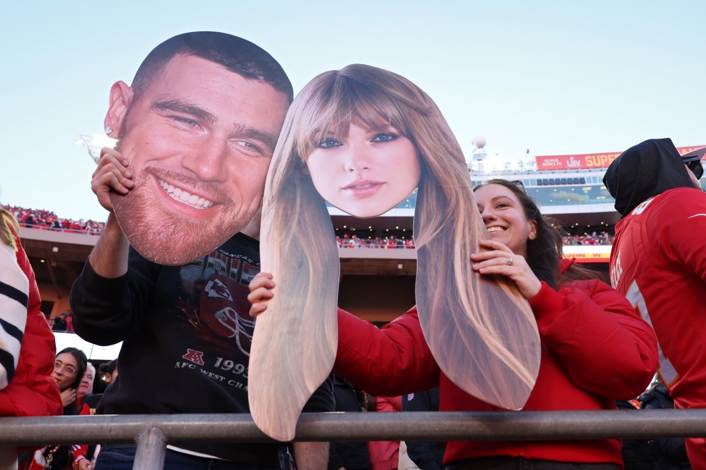 Kansas City Chiefs fans hold up signs of Travis Kelce #87