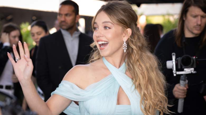 Sydney Sweeney waving at an event