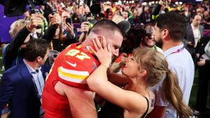 Travis Kelce #87 of the Kansas City Chiefs and Taylor Swift embrace after defeating the San Francisco 49ers 25-22 in overtime during Super Bowl LVIII