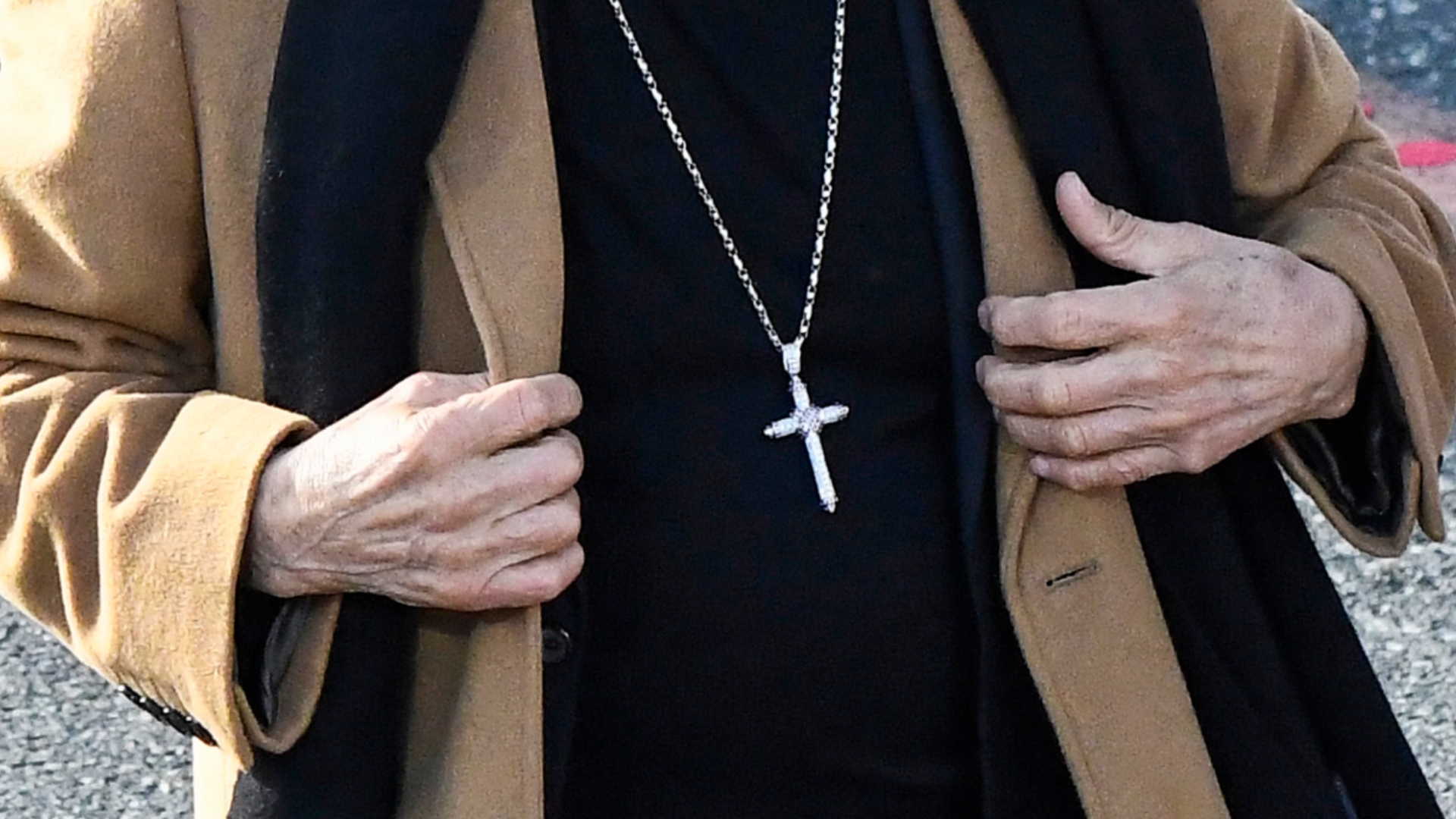 Danny Trejo's hands and cross necklace