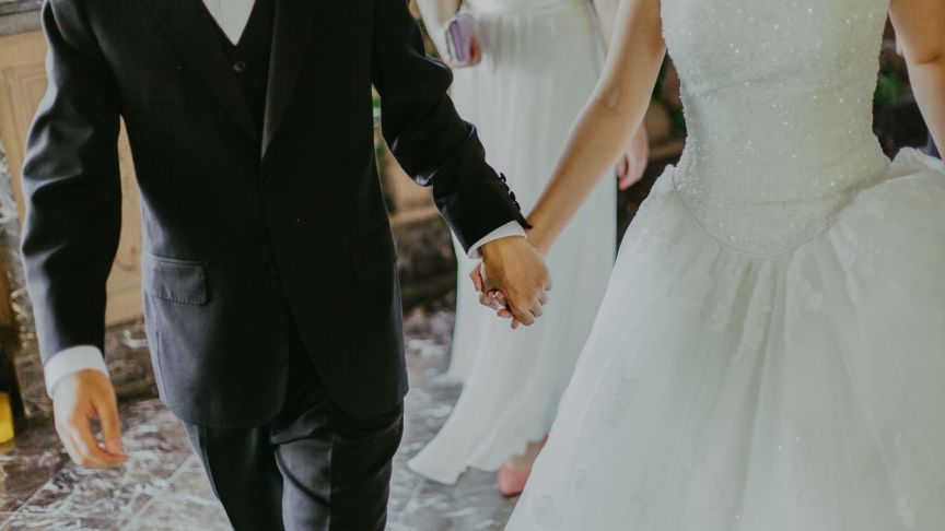 A bride and groom holding hands