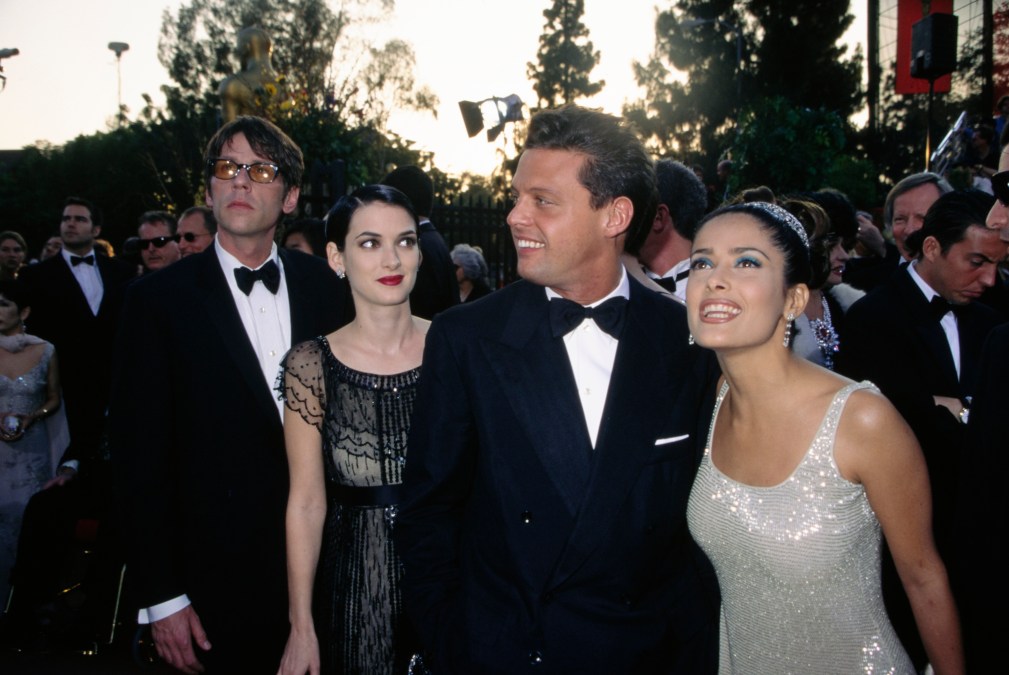 American actress Winona Ryder, wearing a sheer black dress, and her guest, Kevin Healy