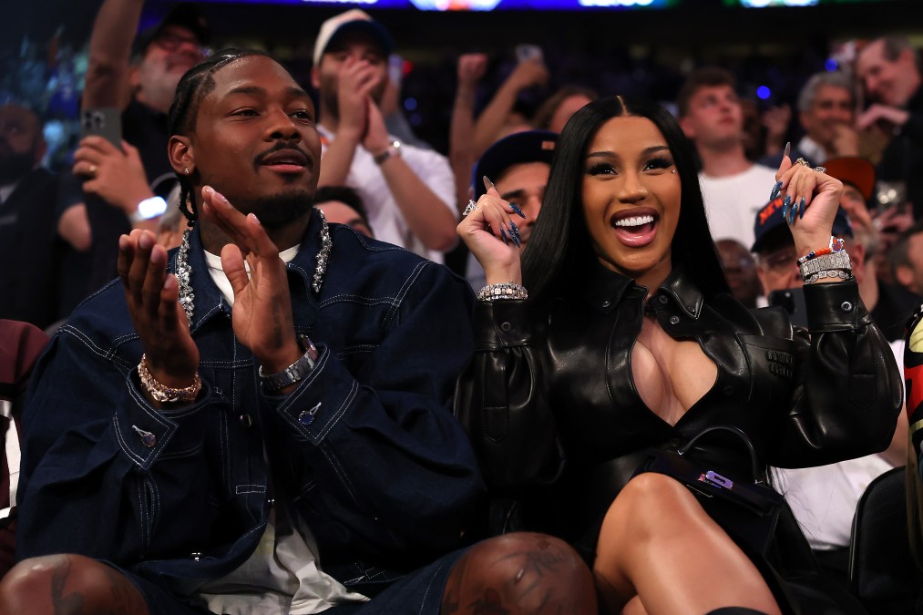 NFL Player Stefon Diggs and rapper Cardi B sits court-side