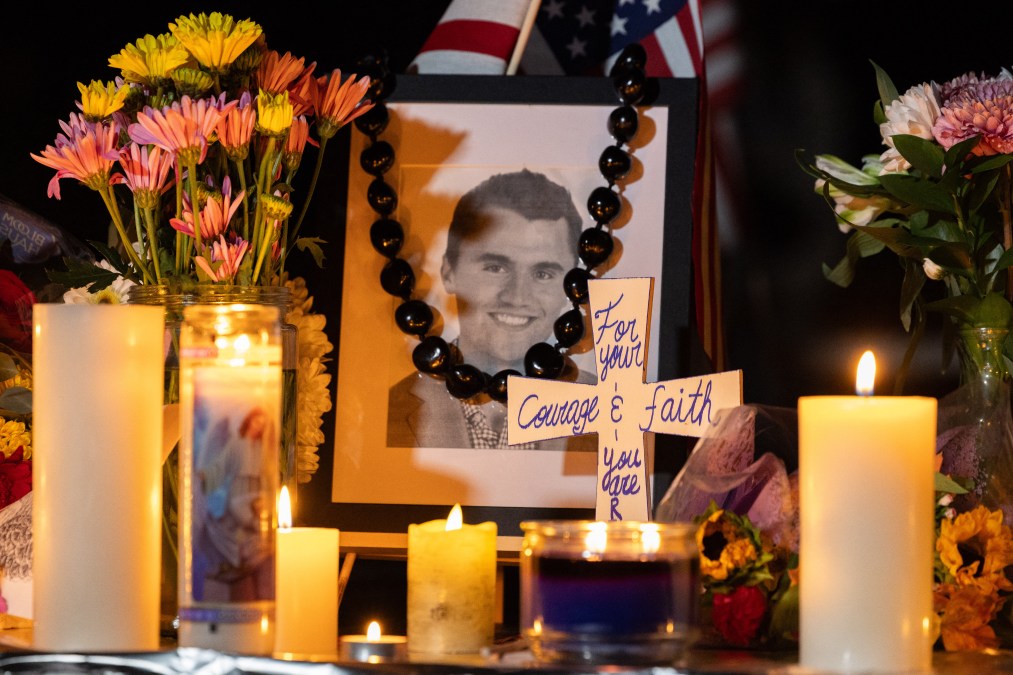 Candles and flowers are seen near a portrait of activist Charlie Kirk 