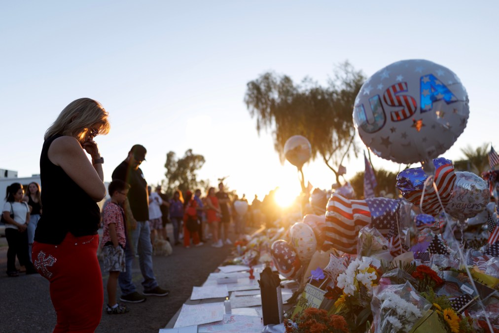 People visit a memorial for Charlie Kirk