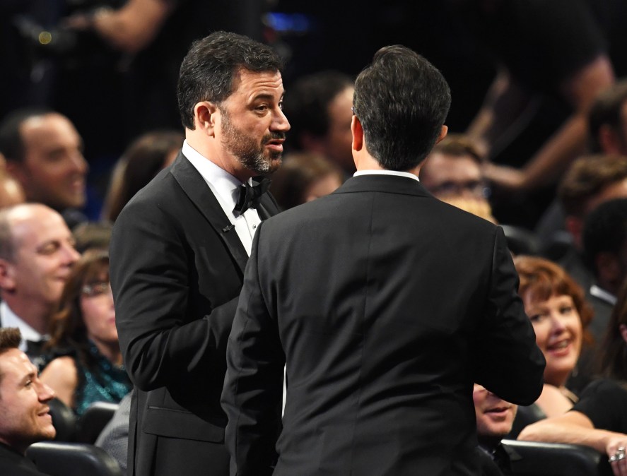 Jimmy Kimmel (L) and host Stephen Colbert speak onstage