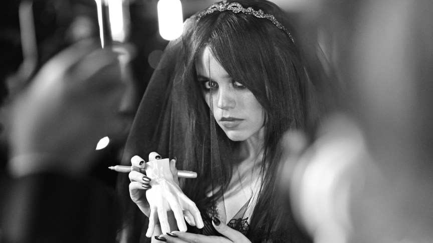 Jenna Ortega poses for photos with a black veil.