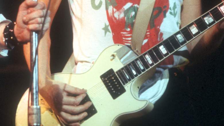 Close up of Steve Jones playing guitar with The Sex Pistols in the 70w